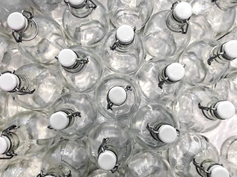 Transparent bottles seen from above. They can be filled with water, wine or other beverage. They are closed by a white plastic cap.