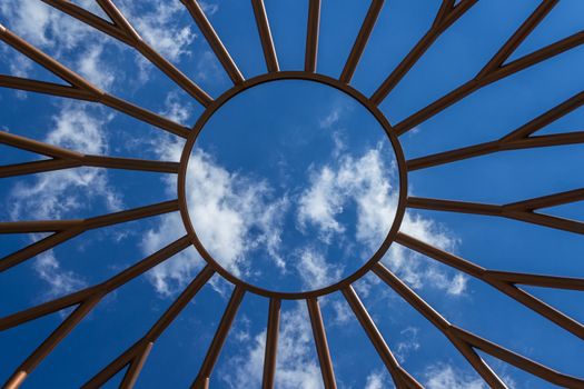 Bottom view of an iron structure, with blue sky in the background.