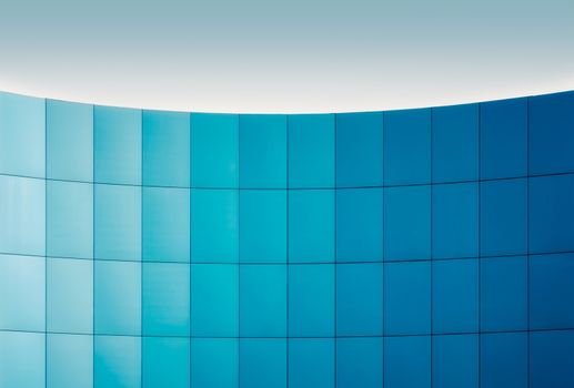 wall of a modern building with a gradation of blue architectural abstract background pattern