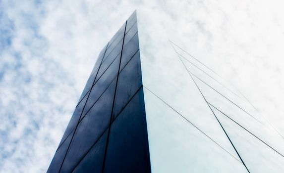 wall of a modern building against the sky and clouds abstract architectural background