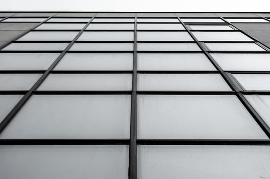 empty windows of a gray high concrete building