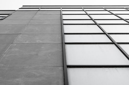 empty windows of a gray high concrete building