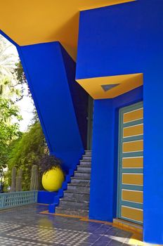 ARCHITECTURAL DETAIL OF A  BUILDING AND GARDEN IN MARRAKECH, MOROCCO.. The colourful modern decoration of the museum building with planted container and plants in the garden of the artist Jacques Majorelle