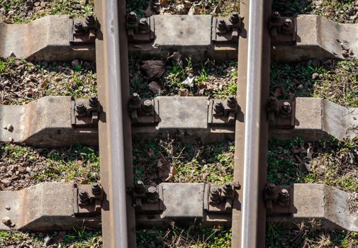 rails and stone sleepers of the old railway technical background in detail close up