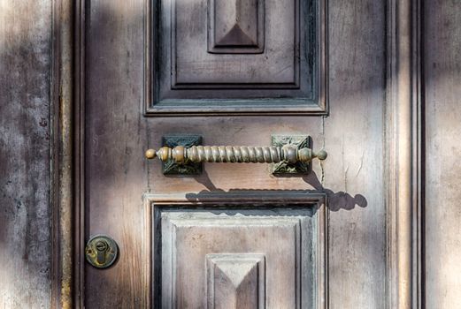 old wooden vintage door with handle and lock retro background close up