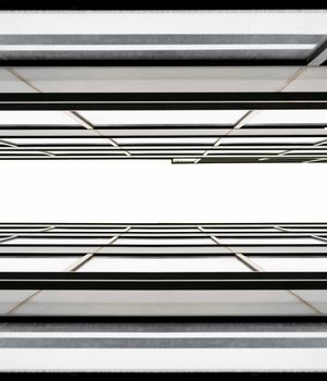 fragment of the wall and windows of a modern tall office building without people  abstract architectural monochromatic background