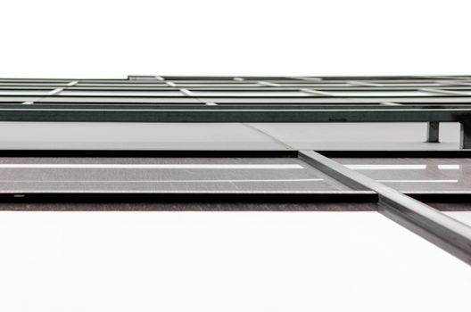 fragment of the wall and windows of a modern tall office building without people  abstract architectural monochromatic background