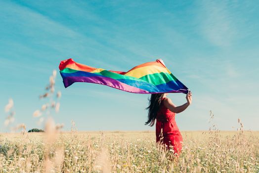 woman with lgbt flag on the field