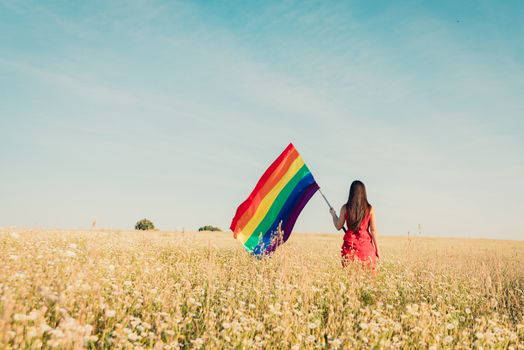 woman with lgbt flag on the field