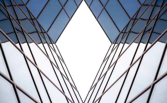 distorted reflection in the mirrored windows of a modern building abstract geometric color blue architectural background pattern