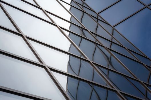 reflection with distortion in the window of a modern building color blue abstract urban background