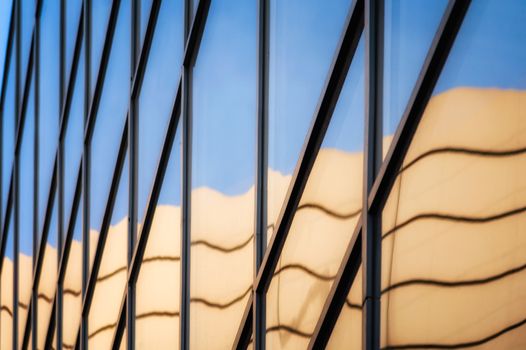 reflection with distortion in the window of a modern building color blue abstract urban background