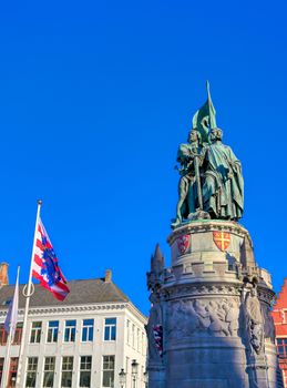 The Jan Breydel and Pieter de Coninck statue located in the historical city center and Market Square (Markt) in Bruges (Brugge), Belgium on a sunny day.