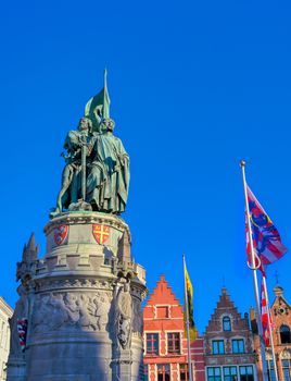 The Jan Breydel and Pieter de Coninck statue located in the historical city center and Market Square (Markt) in Bruges (Brugge), Belgium on a sunny day.