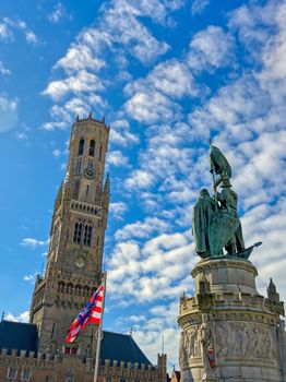 The Jan Breydel and Pieter de Coninck statue located in the historical city center and Market Square (Markt) in Bruges (Brugge), Belgium on a sunny day.