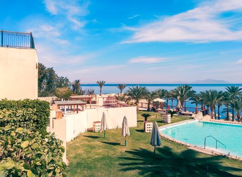 empty hotel lawn with folded umbrellas on the coast of southern Sinai Egypt Sharm El Sheikh