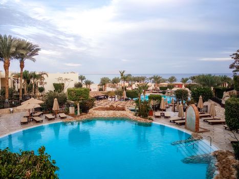 empty hotel lawn with folded umbrellas on the coast of southern Sinai Egypt Sharm El Sheikh