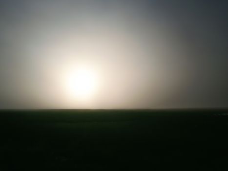 sunset in the evening over a field at dusk without people abstract gradient landscape background