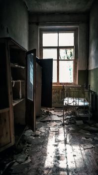 room with a window with a bed in an abandoned house in Chernobyl Ukraine