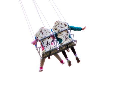 children ride on a carousel in an amusement park isolated on white background