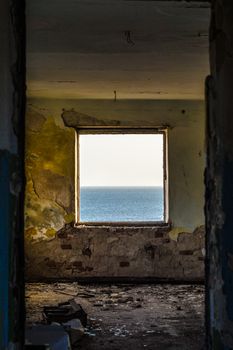 sea horizon in the window of the destroyed shabby room