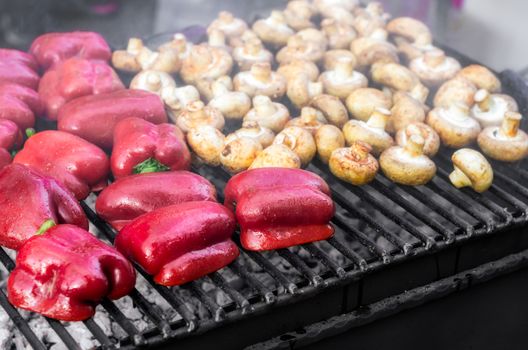 grilled red bell peppers and mushrooms champignons close up