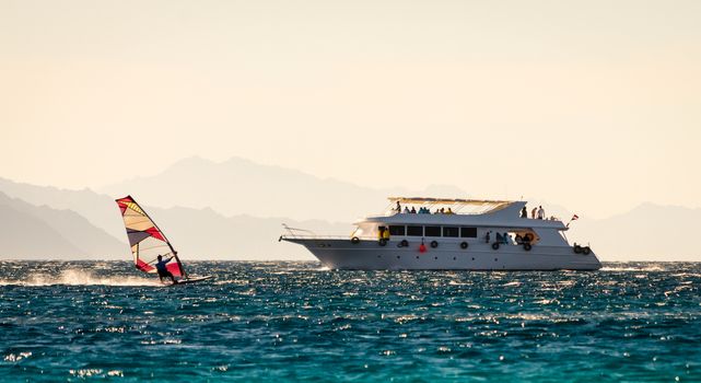 big boat and windsurfer on the background of high mountains in Egypt Dahab