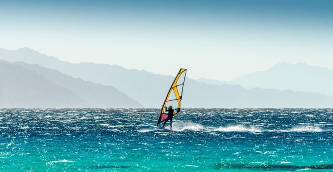 windsurfer rides on a background of high mountains in Egypt Dahab