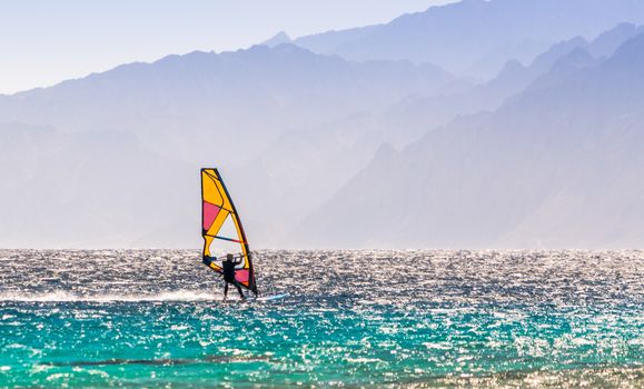 windsurfer rides on a background of high mountains in Egypt Dahab