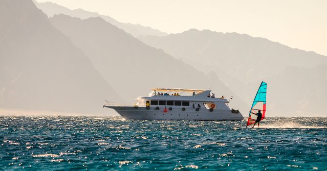 big boat and windsurfer on the background of high mountains in Egypt Dahab