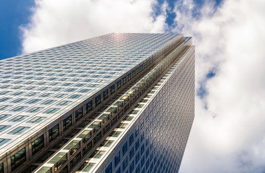 Modern glass exterior of corporate office buildings shot from a low angle.