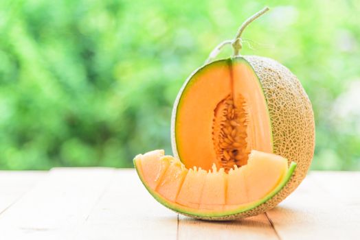 Fresh Orange melon on wood plate