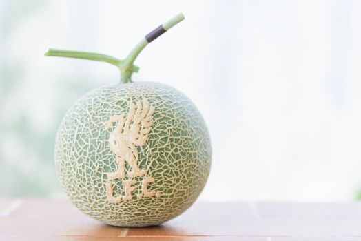 Fresh melon with liverpool logo on peel