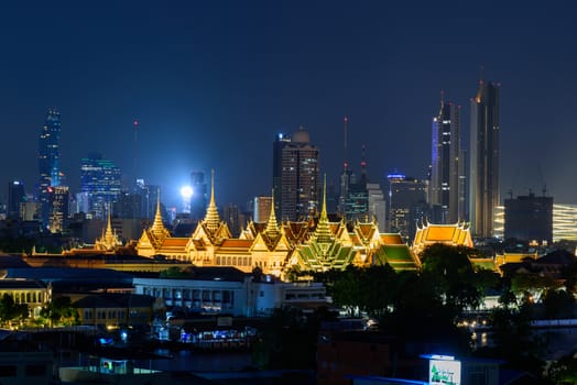 Bangkok , Thailand - 19 June, 2020: Wat Phra Keaw Public landmark of Thailand in night time and city in background