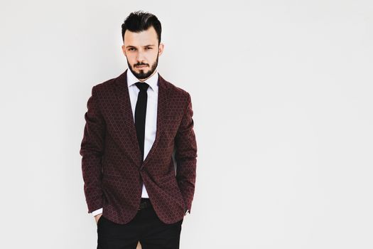 Handsome and elegant fashionable man or businessman posing a white background