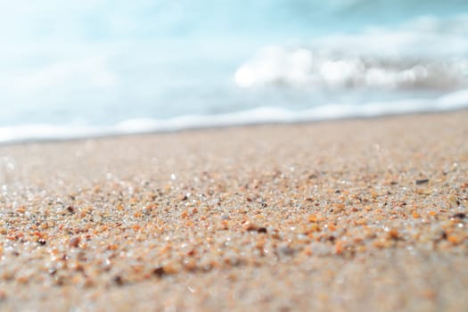 Top view of sand and water clean beach and white sand in summer with sun light blue sky and bokeh abstract  background.