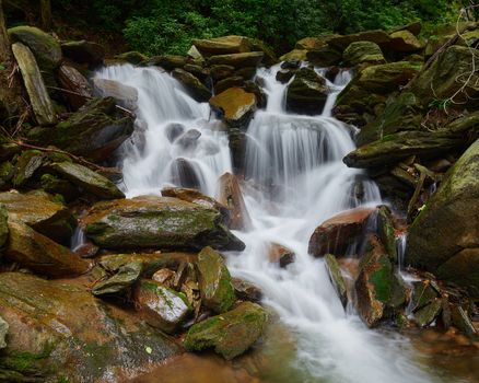 Waterfall pouring over rocks in Pisgah National Forest, NC.