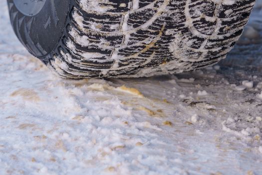 Tire for winter with spikes and its imprint on the road covered with snow