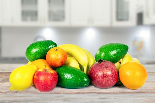 Healthy eating concept - group of various fruits on a wooden table in the kitchen in close-up