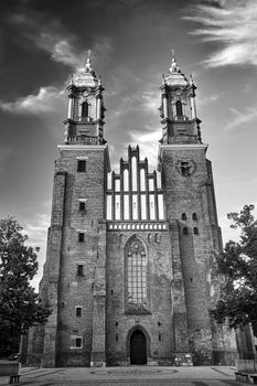 Gothic facade and bell towers of the historic Poznan cathedral, black and white