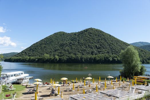 pidiluco,italy june 22 2020 :piediluco lake and its beach with ferry in the middle of the lake