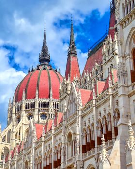 The Hungarian Parliament Building located on the Danube River in Budapest Hungary at sunset.