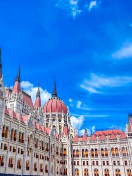 The Hungarian Parliament Building located on the Danube River in Budapest Hungary at sunset.