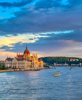 The Hungarian Parliament Building located on the Danube River in Budapest Hungary at sunset.