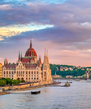 The Hungarian Parliament Building located on the Danube River in Budapest Hungary at sunset.