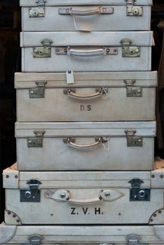 A pile of white suitcases