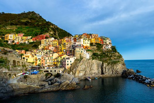 Colorful traditional houses on a rock over Mediterranean sea, Manarola, Cinque Terre, Italy