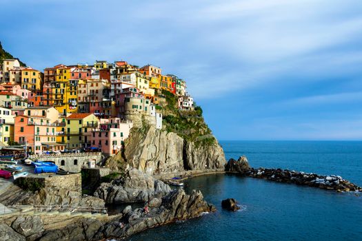 Colorful traditional houses on a rock over Mediterranean sea, Manarola, Cinque Terre, Italy
