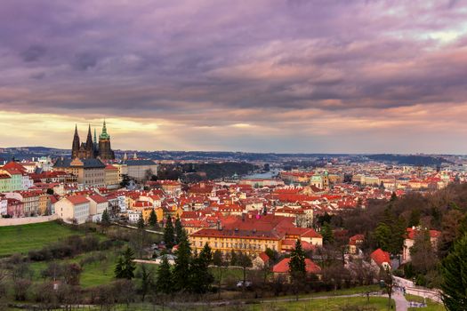 View of Prague and Prague castle from Petrin hill at sunset with dramatic sky. Czechia
