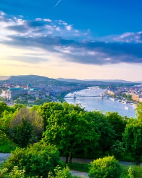 A view along the Danube River of Budapest, Hungary from Gellert Hill at sunset.